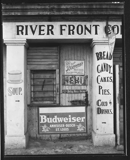 [Painted and Posted Advertisements on Façade of "River Front" Coffee Shop]