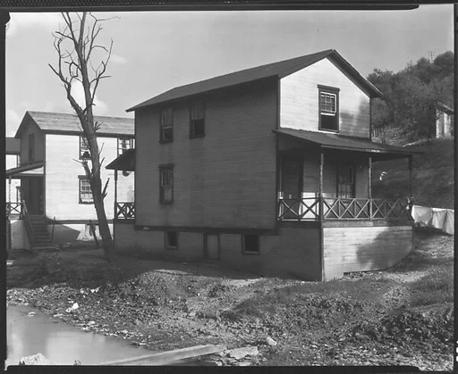 [Row of Clapboard "Company" Houses for Miners Along Creek, Osage, West Virginia]