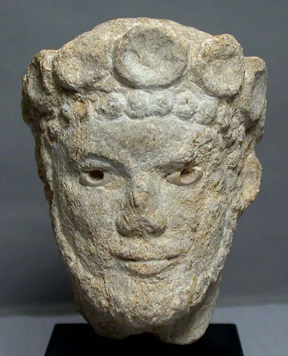 Limestone head of a bearded man