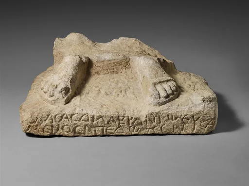 Inscribed limestone plinth with the feet of a statue of Zeus