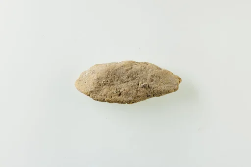 Fragment of clay lump with impressions of beads