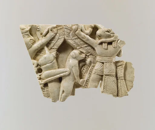Furniture plaque carved in relief with winged figures, locust, and monkey