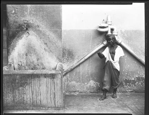 [Statue and Outdoor Faucet in Courtyard, Havana]