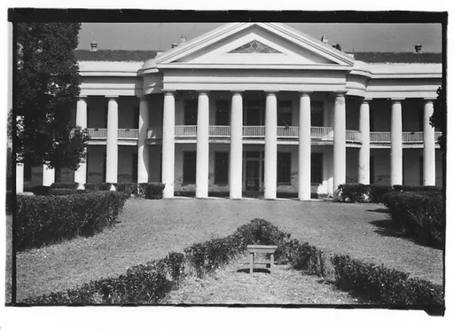 [Façade of Large Greek Revival Building with Lawn Bench in Foreground, Convent, Louisiana]