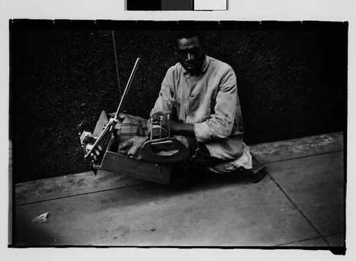 [Legless Man in Dolly on Street, New Orleans, Louisiana]
