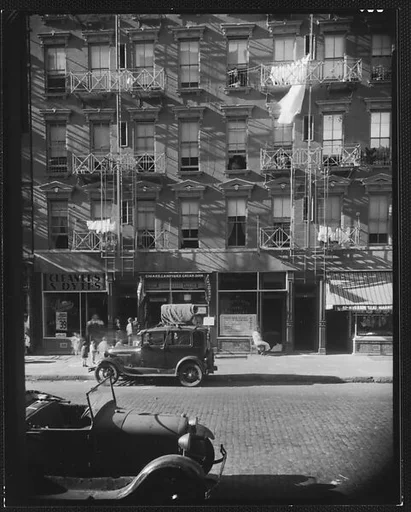 [Apartment Building with Ground Floor Shops and Parked Cars in Front, 41-43 Carmine Street, New York City]