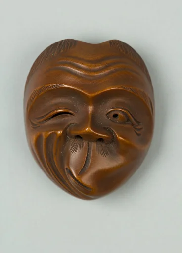 嘯吹面木彫根付　銘:斎山|Netsuke of Usofuki Mask