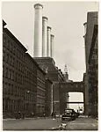 [City Street Ending at Factory with Four Smokestacks]