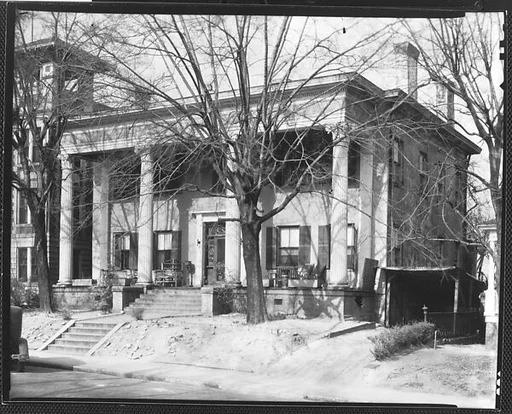 [Greek Revival House with Corinthian Capitals and Adjacent Garage Shack, Behind Trees, Macon, Georgia]