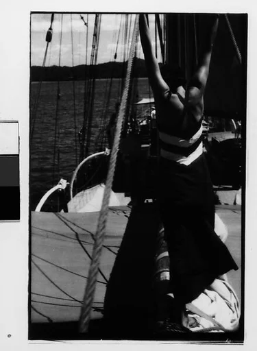 [One 35mm Film Frame: South Seas: Isabelle Jennings With Upraised Arms on Cressida Deck, From Behind]
