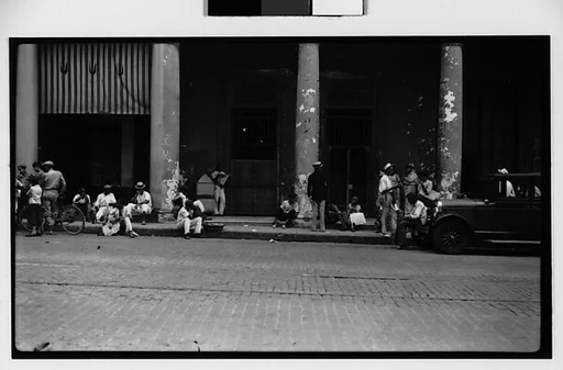 [Street Scene with Men Standing and Seated on Sidewalk, Havana]