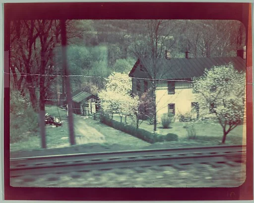 [House and Railroad Tracks from Moving Train, For Fortune Article "Along the Right of Way"]