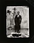 Young man in cravat with potted plant — Alex Agbaglo Acolatse
