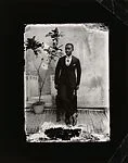Young man in cravat with potted plant