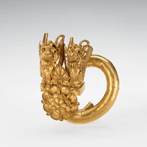 Gold spiral with double lion-griffin-head terminal