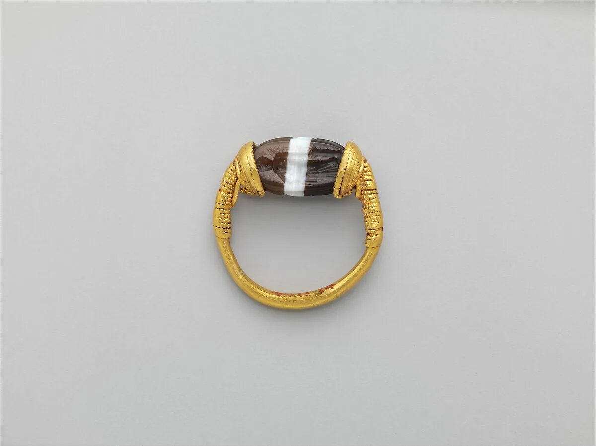 Gold and banded carnelian ring: on scarab bezel, a youth — Unknown