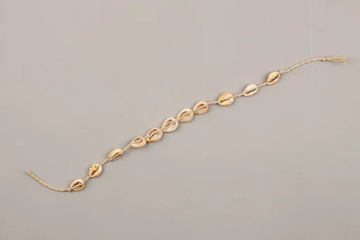 String of cowrie shell beads on fiber