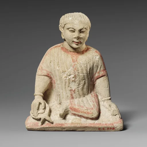 Limestone statuette of a temple boy