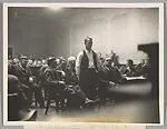 CROWN POINT, IND. John Dillinger, the notorious outlaw, as he stood in a Crown Point Court today, and heard his death trial set for March 12. Dillinger is pictured as he heard the arraignment — Unknown