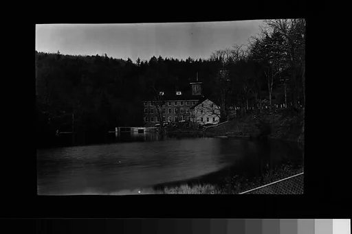 [Brick Mill and Clapboard Buildings on River]