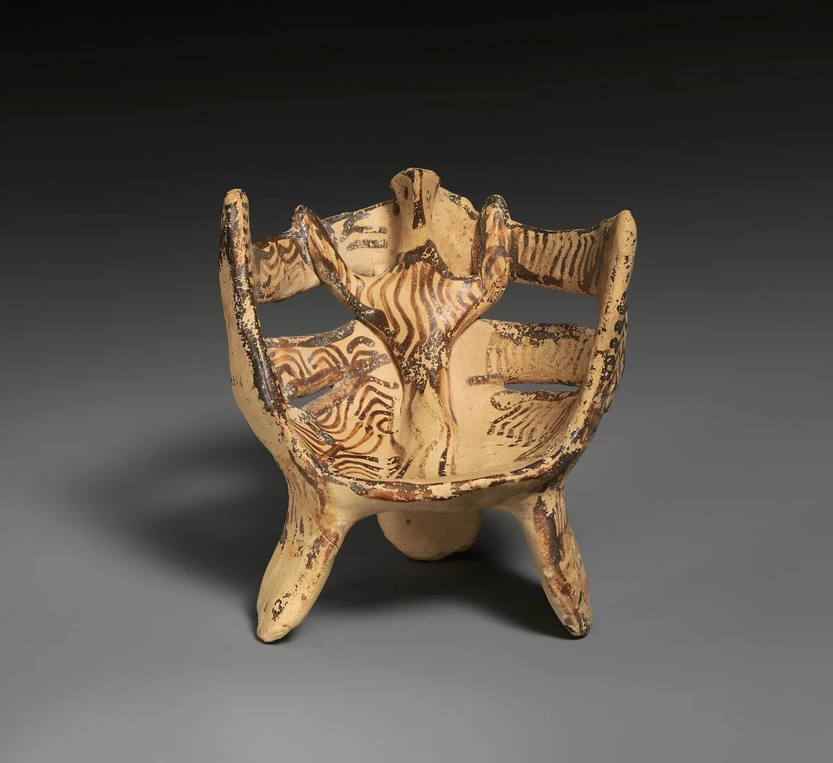 Terracotta female figure in three-legged chair — Unknown