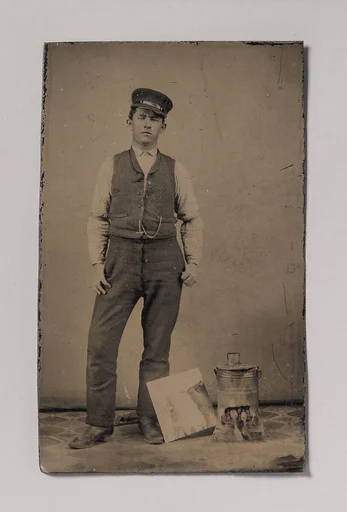 [Tinsmith with Coal Heater and Sheet of Tin]