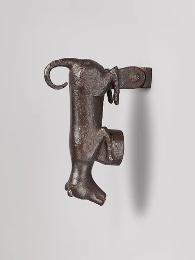 Door knocker in the shape of a small dog or puppy