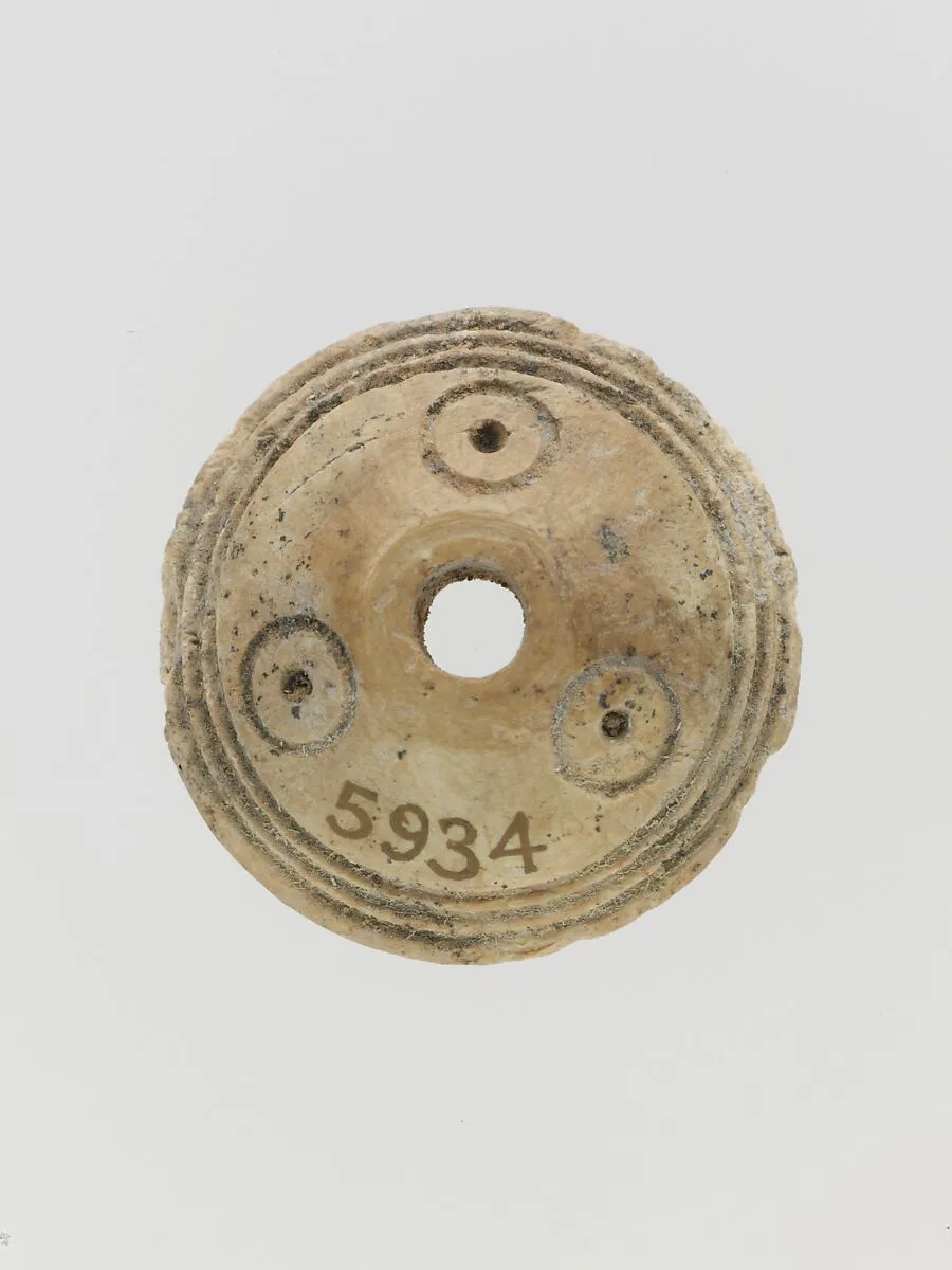 Bone spindle whorl — Unknown