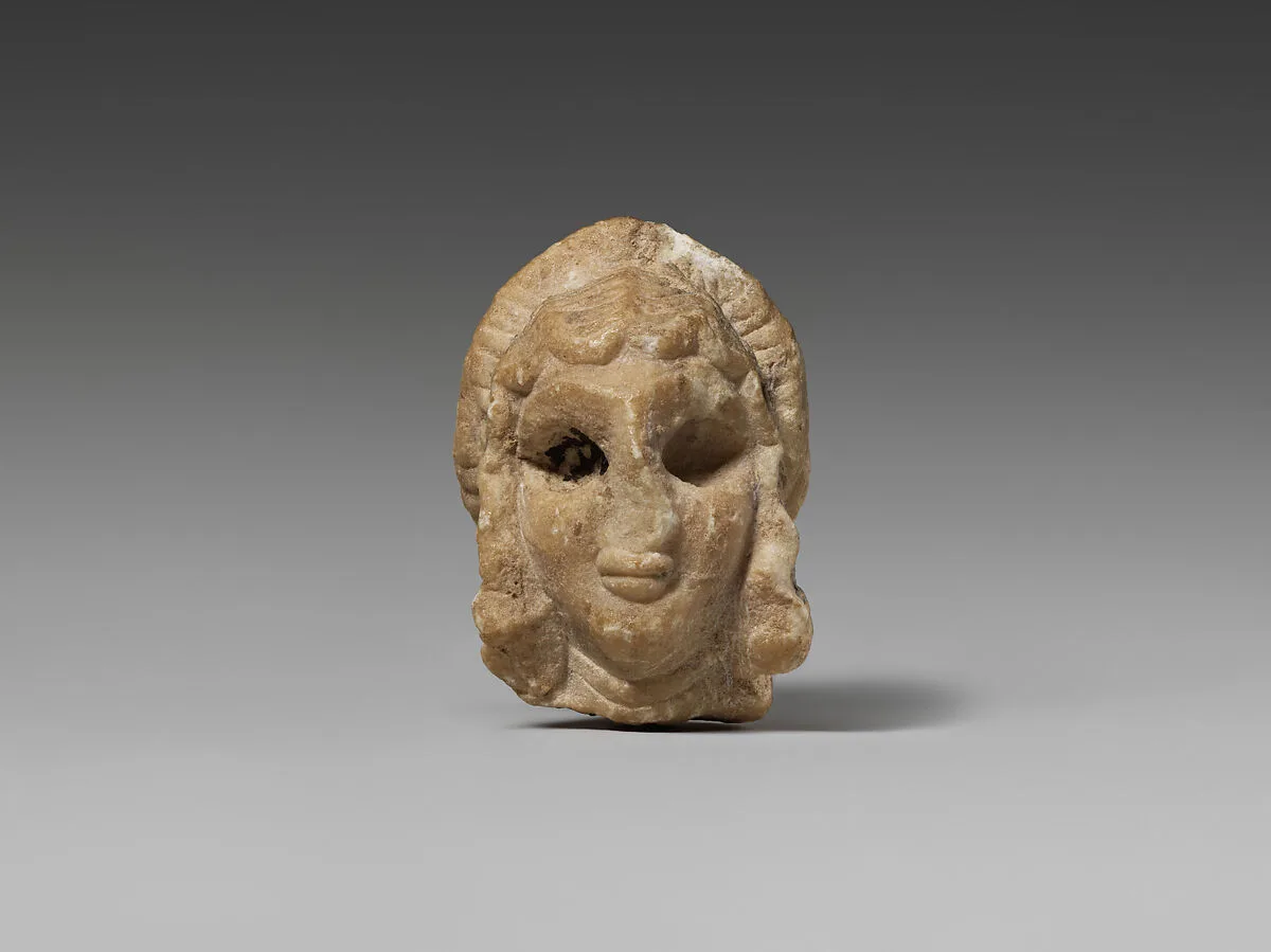 Female head with elaborate hairstyle — Unknown