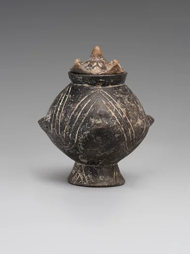 Vessel with a lid and incised decoration