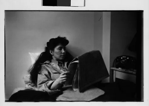 [Five 35mm Film Frames: Jane Smith Evans Reading Newspaper in Bed, New York City]