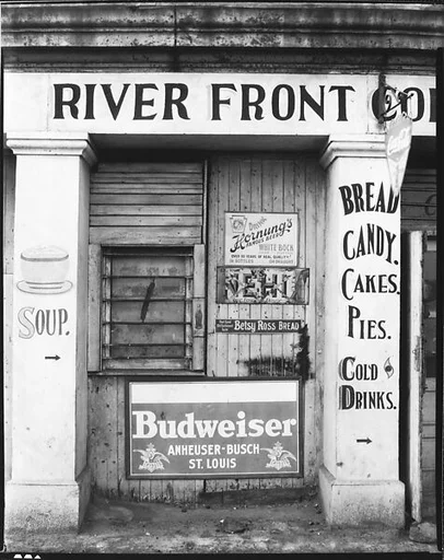 [Painted and Posted Advertisements on Façade of River Front Coffee Shop]