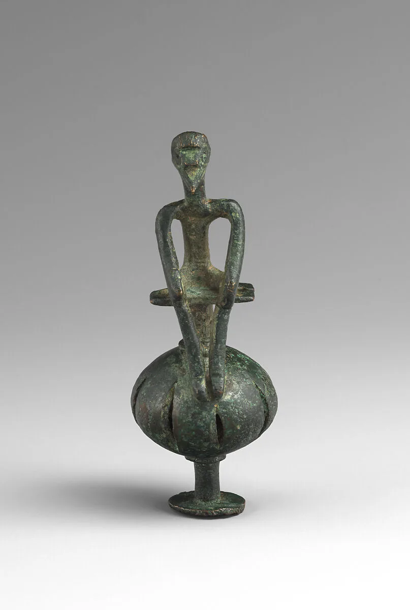 Bronze man seated on a ball — Unknown