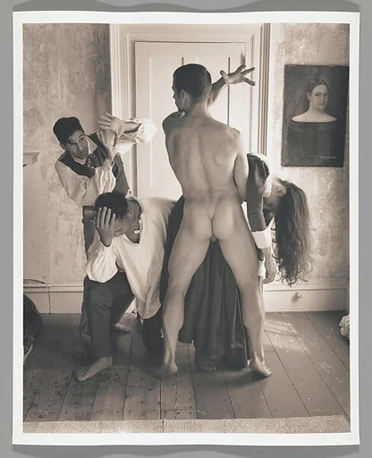 [Group of Three Men and One Woman before Closed Door]