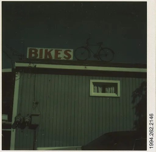 [Sign: "Bikes" and Bicycle on Roof]