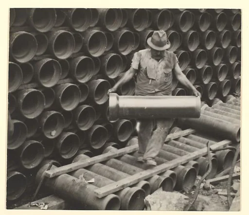 [Worker Carrying Large Water Pipe, New York]
