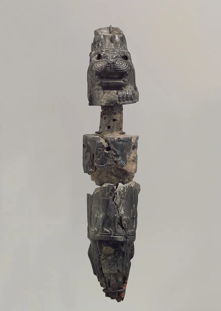 Furniture leg (?) with a recumbent lion supporting a deity — Unknown