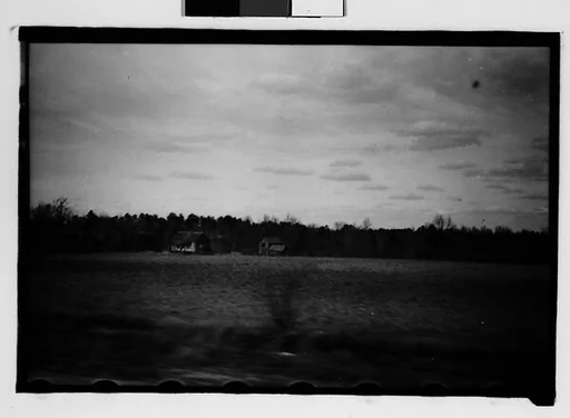 [Wooden Houses in Field, From Moving Automobile, Macon, Georgia]