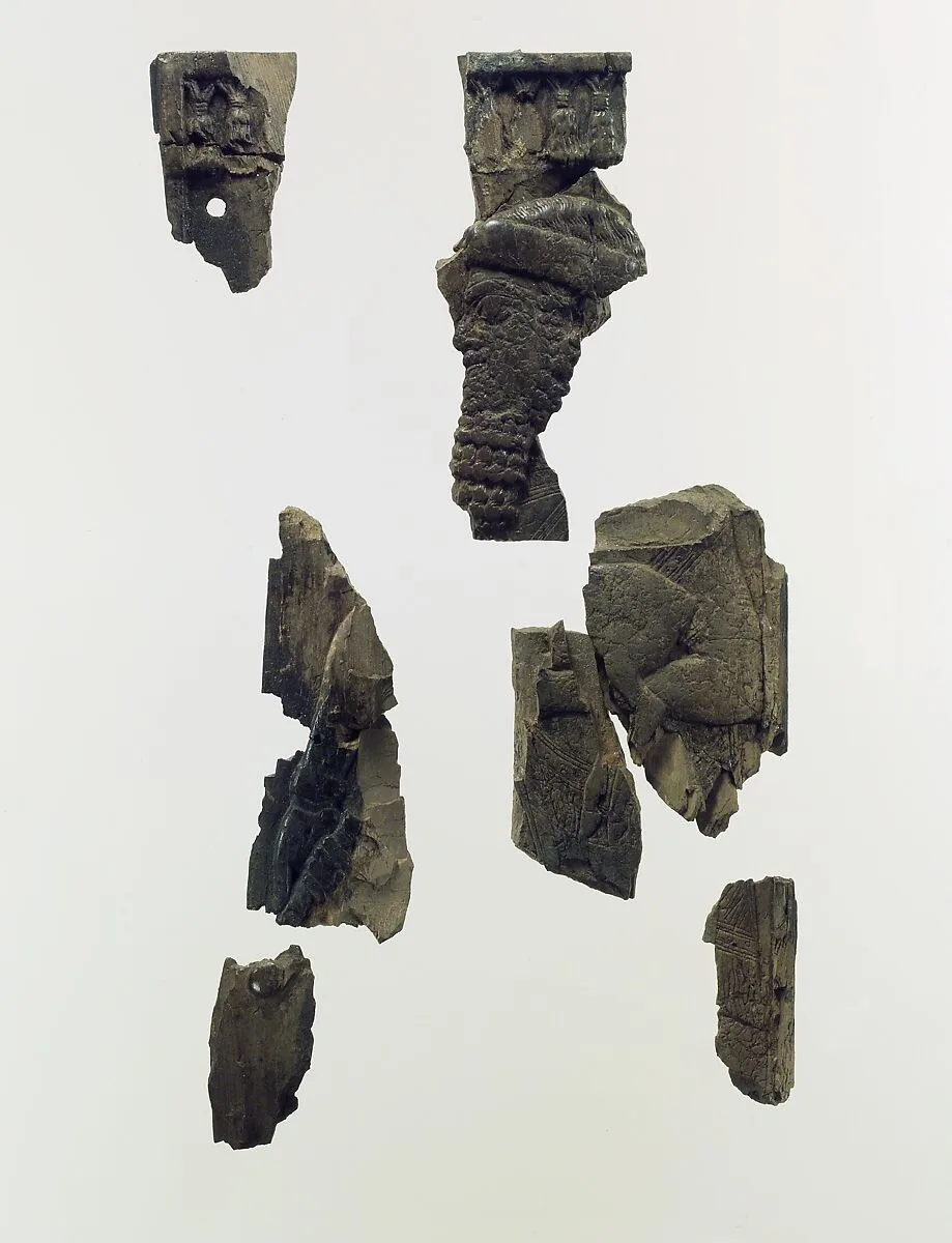 Plaque fragments with a bearded male dignitary carrying a young goat — Unknown
