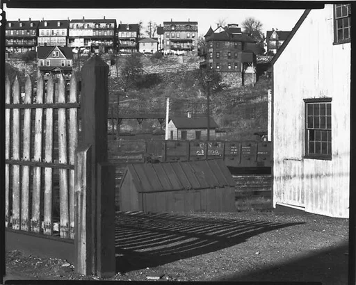 [Railroad Yard Below Workers' Houses with Wooden Fence and Barn in Foreground, Bethlehem, Pennsylvania or Philipsburg, New Jersey]
