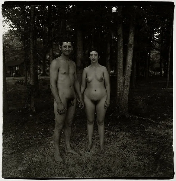 A husband and wife in the woods at a nudist camp, N.J. — Diane Arbus