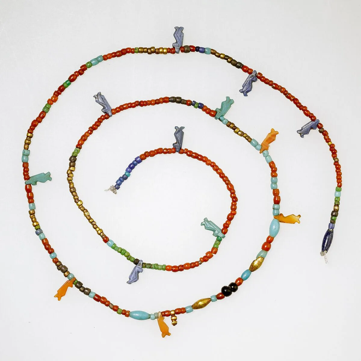 String of tiny disk beads, barrels, and 13 Taweret amulets — Unknown