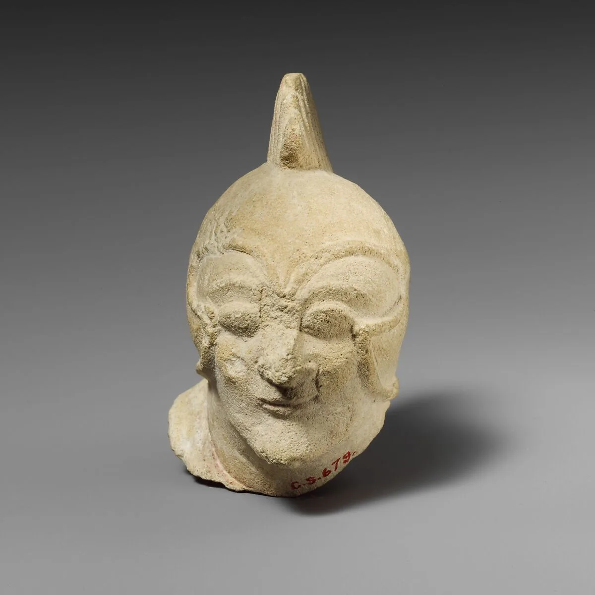 Limestone head of a beardless male with a helmet of Greek type — Unknown