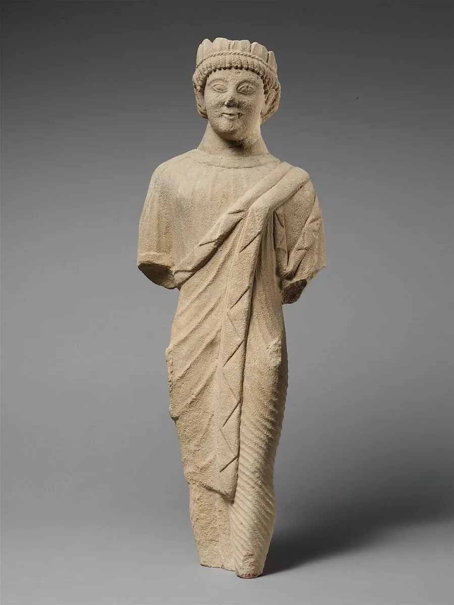 Limestone statuette of a beardless male votary in Greek dress with a wreath of leaves — Unknown