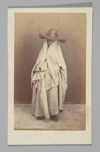 [Studio Portrait: Woman Wearing Robe and Straw Hat, Algeria]