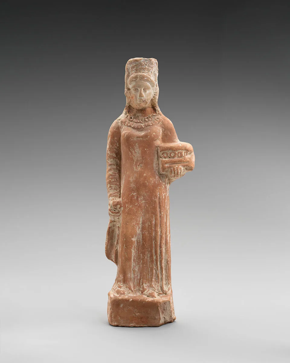 Terracotta figurine of a standing female votary holding a box — Unknown