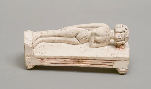 Reclining female figure on a bed