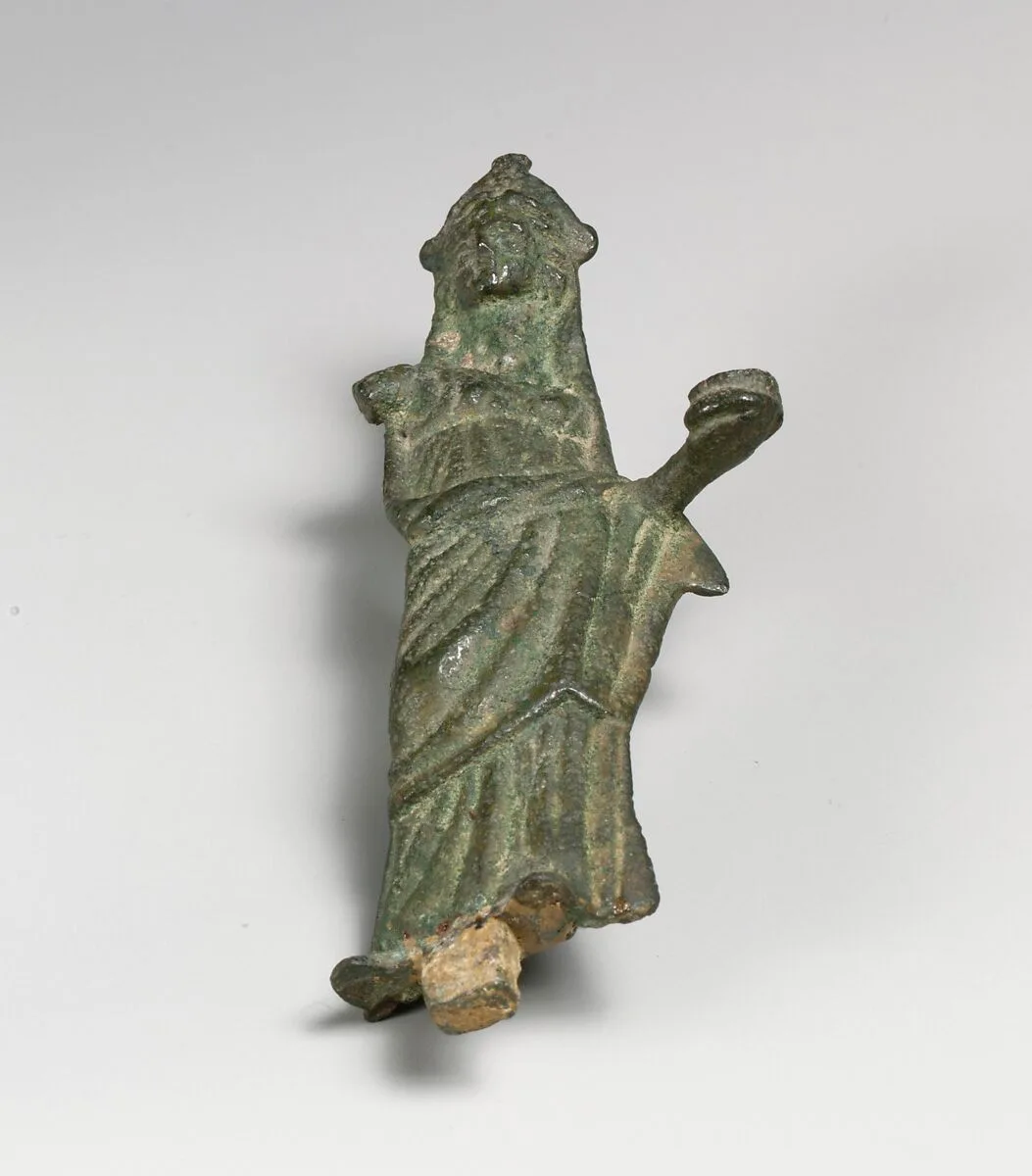 Statuette of a woman wearing a mantle over head — Unknown