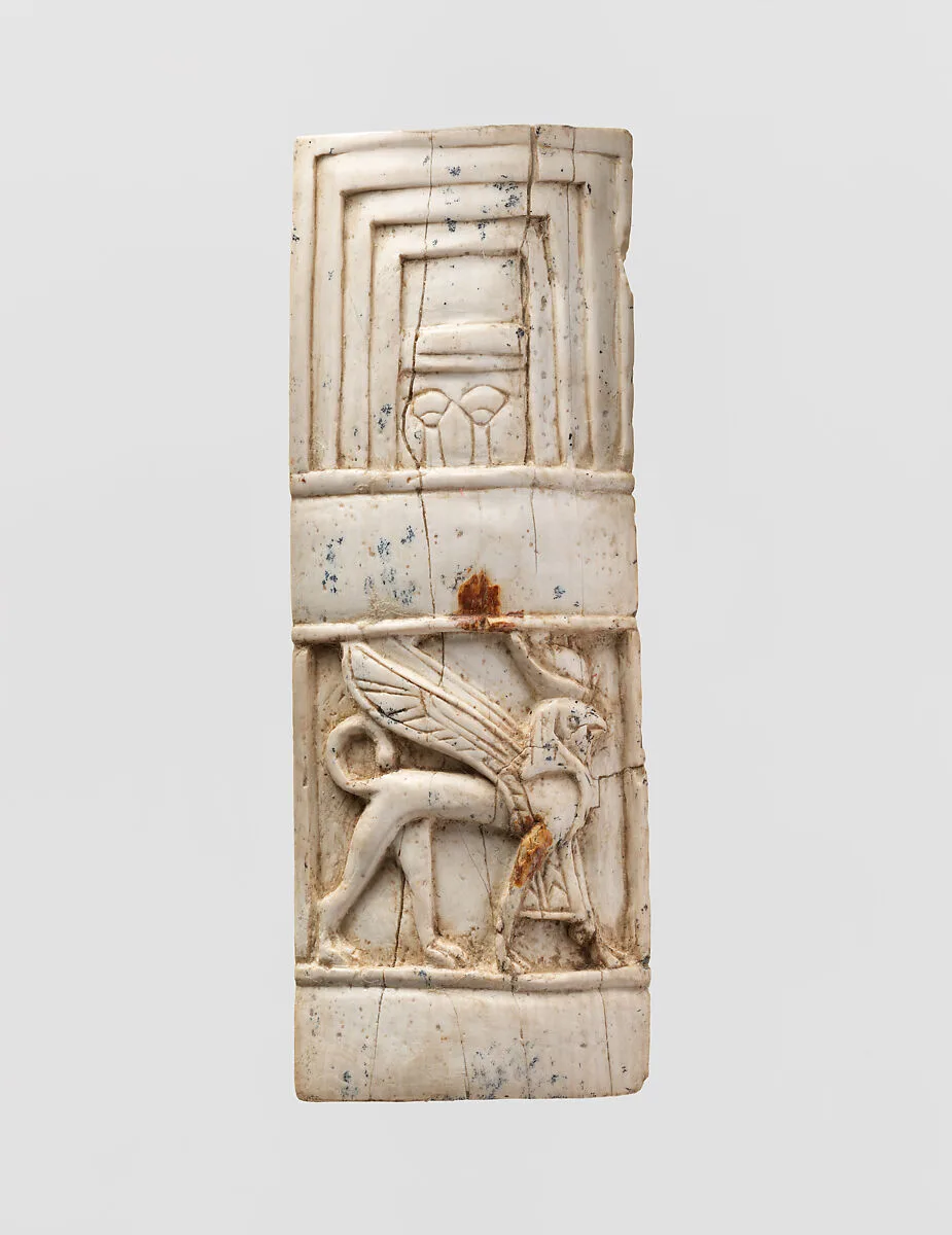 Furniture plaque carved in relief with window and sphinx — Unknown