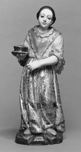 Standing woman with a bowl on a plate from a nativity